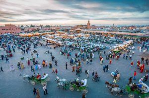 Morocco, Marrakech, a crowd of local people and tourists in the famous square Jemaa el Fna.